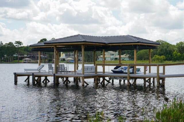covered boat dock with deck and outdoor furniture