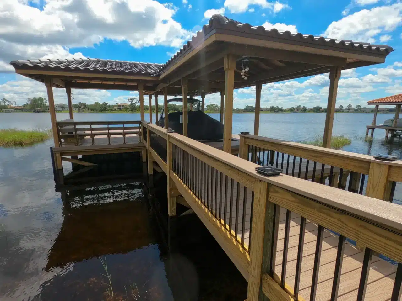 Photo of a covered boat dock with deck area and walkway