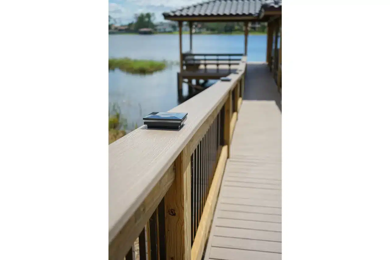 Photo of a deck railing and walkway leading to a covered boat dock