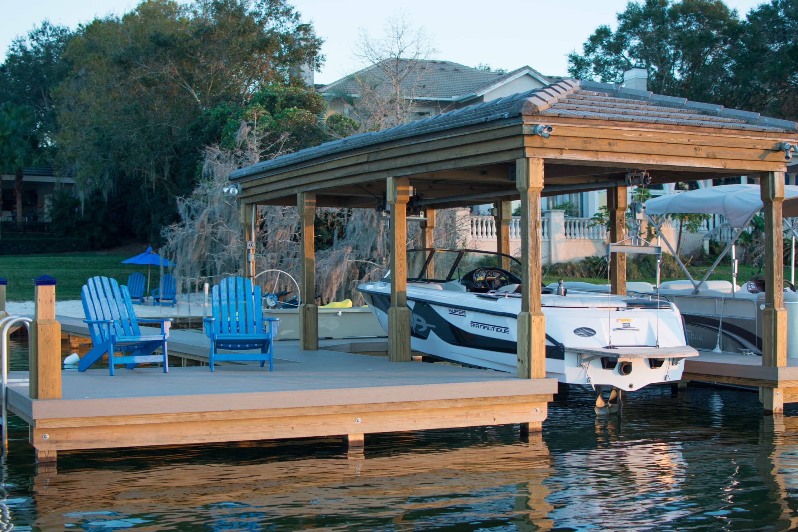 preparing a boat for a hurricane - boat in a dock with loose chairs on the dock