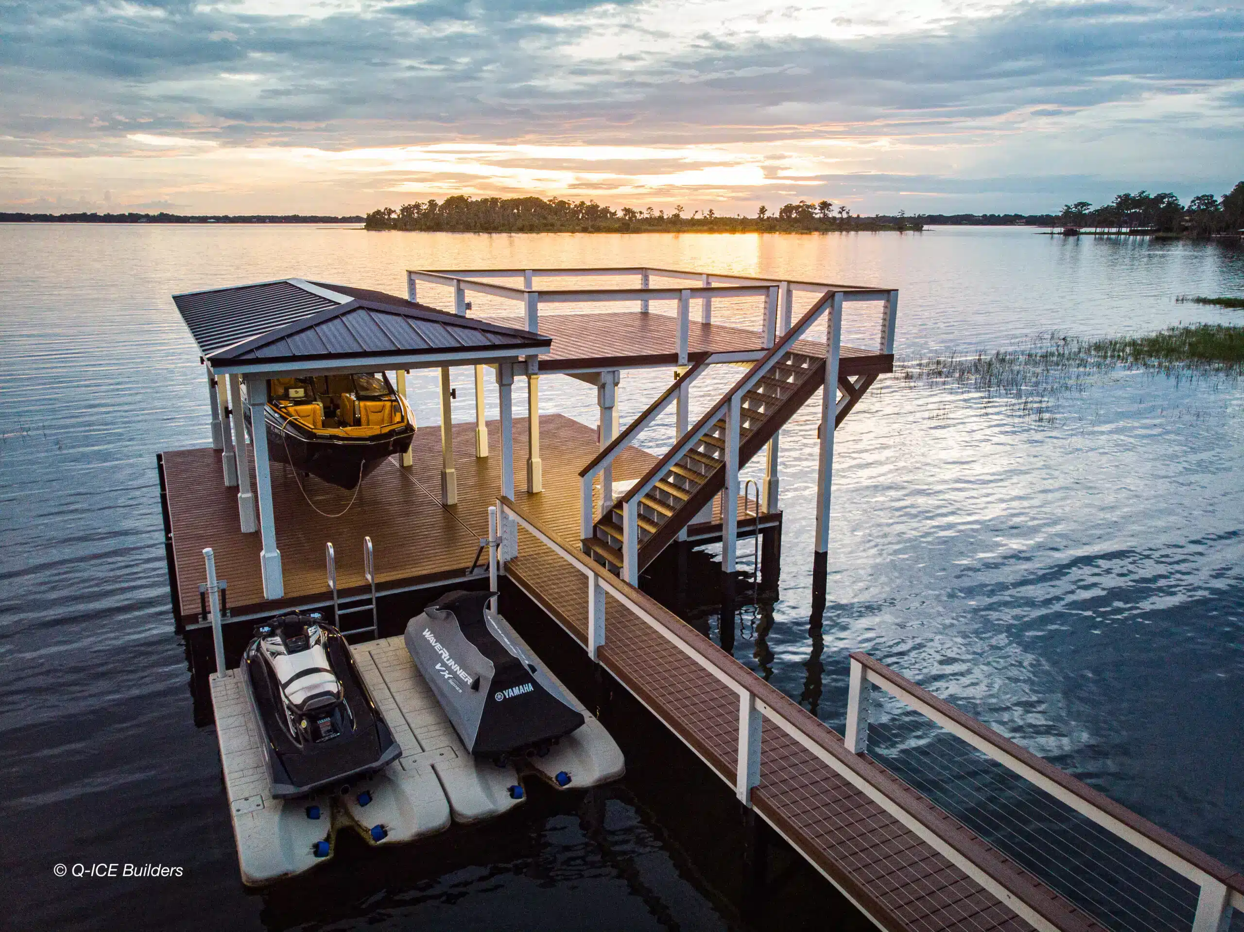 boat dock with a boat lift, upper level deck and personal watercraft lifts - Boat dock builder in Central Florida