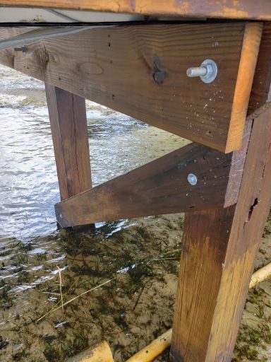 prep a boat dock for storms - wooden boat dock posts with bolts used to secure to beams.